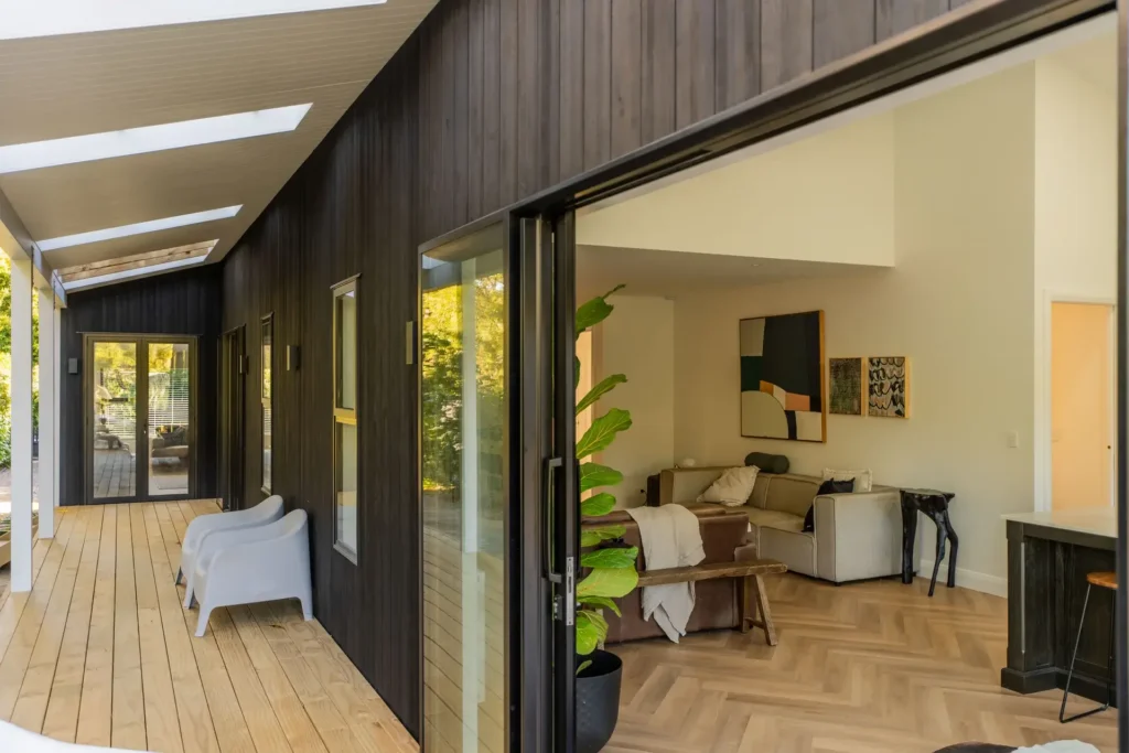 Black-clad contemporary family home at 12 Kohekohe Road, Waikanae, with a warm timber interior