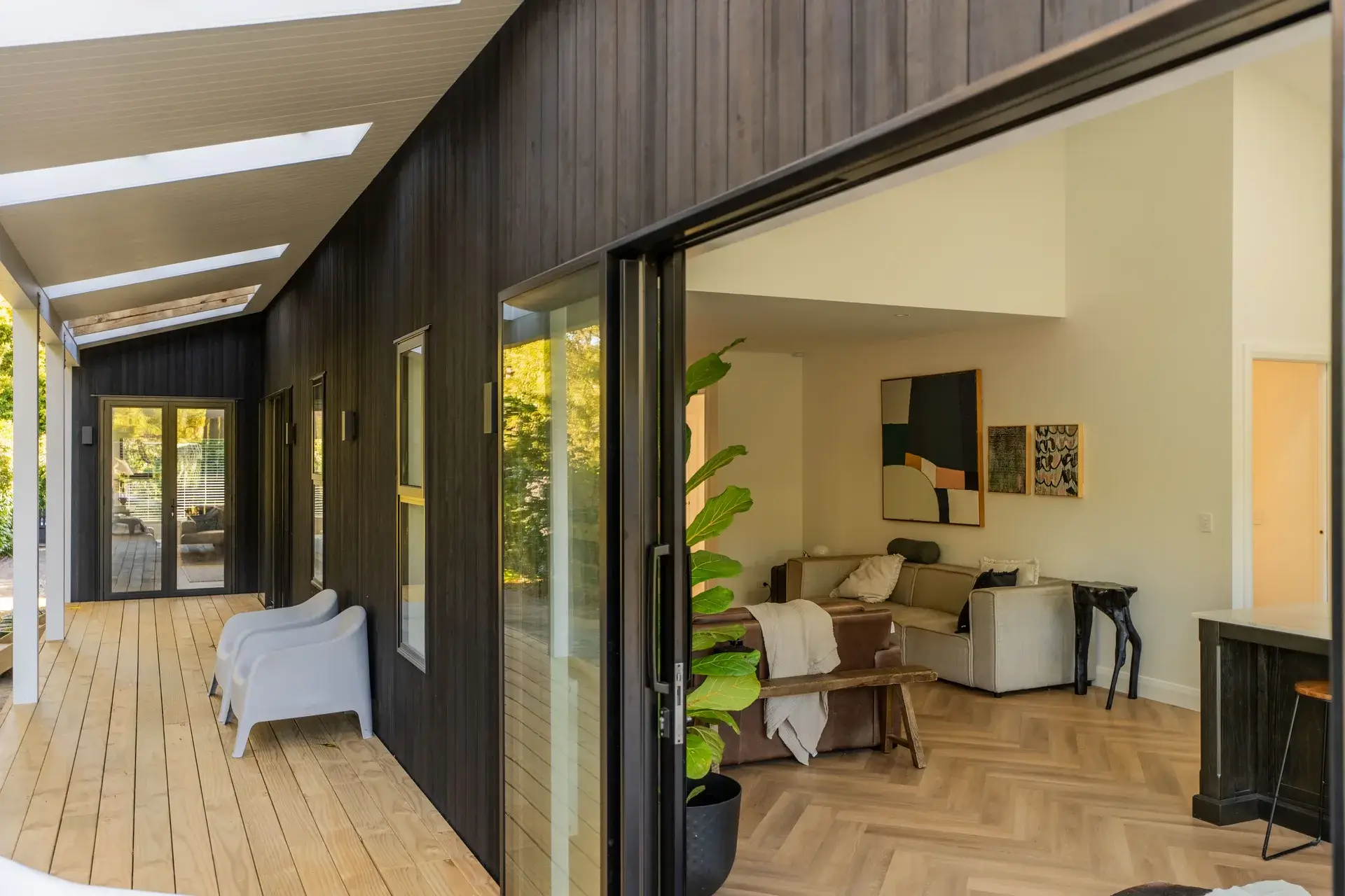 Black-clad contemporary family home at 12 Kohekohe Road, Waikanae, with a warm timber interior