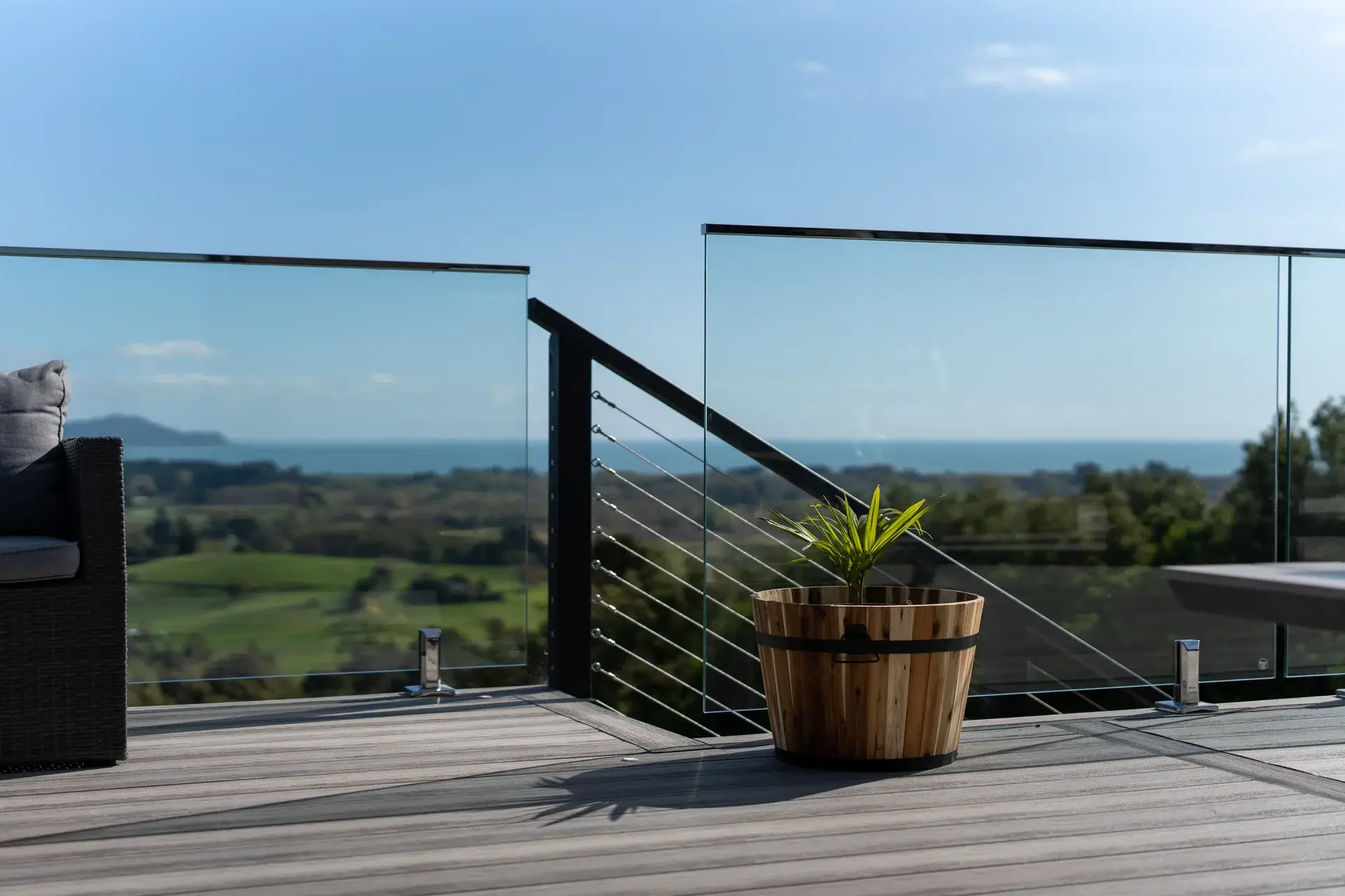 Composite deck with a glass balustrade looking over farmland to the sea, Huia Street, Waikanae