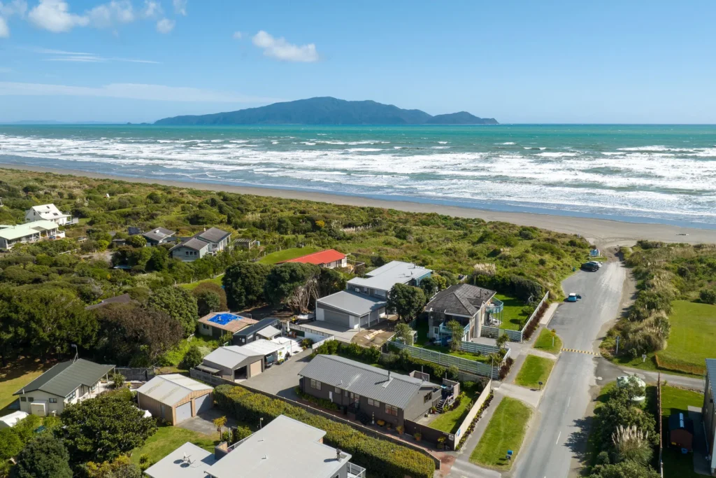 Beachfront Living Elevated - aerial view of Peka Peka Beach with Kāpiti Island across the water
