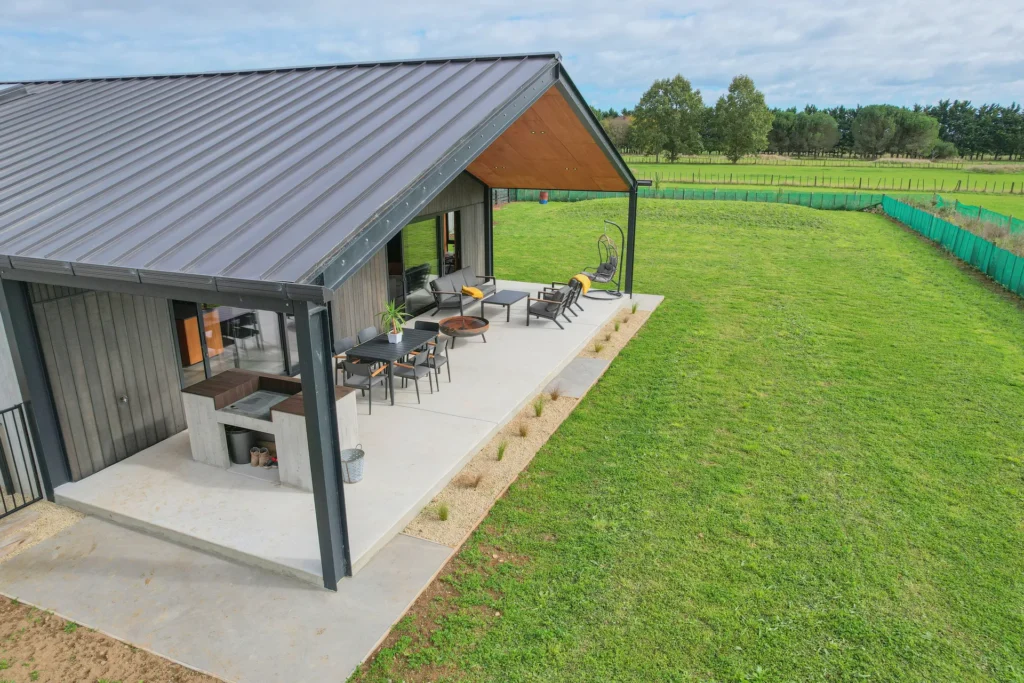 Rural Barn Retreat - barn-form home with steel-framed covered patio beside the paddocks