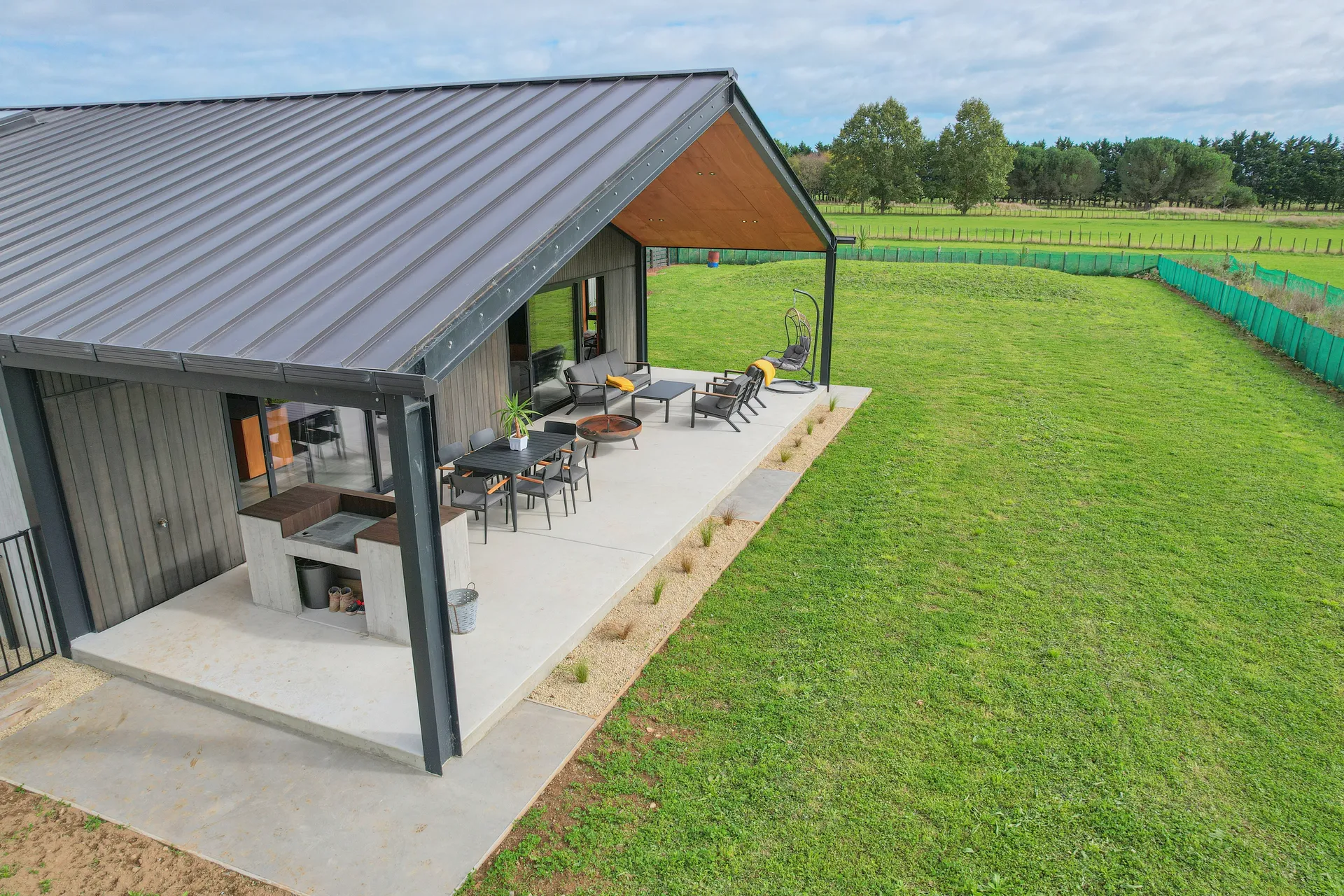 Rural Barn Retreat - barn-form home with steel-framed covered patio beside the paddocks