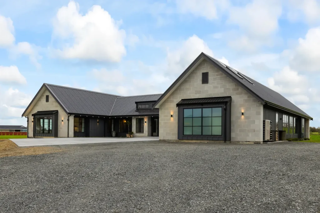 Country Estate Elegance - front elevation with schist-toned block gables, dark standing-seam roof and black-framed windows