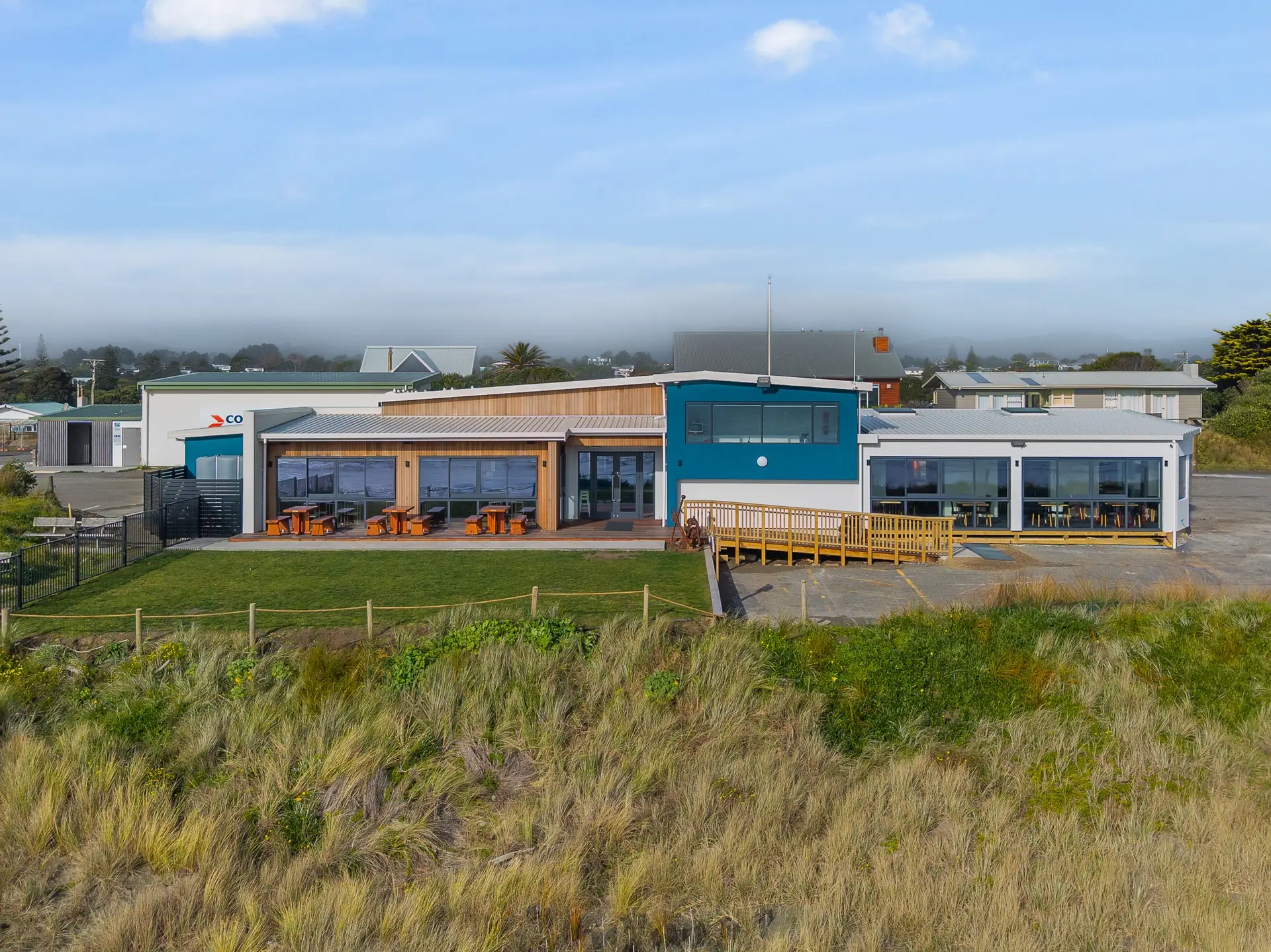 Rebuilt Waikanae Boating Club on its beachfront site, modern two-tone commercial exterior